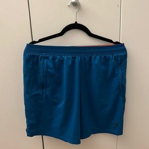 Gymshark 7inch blue running shorts.
